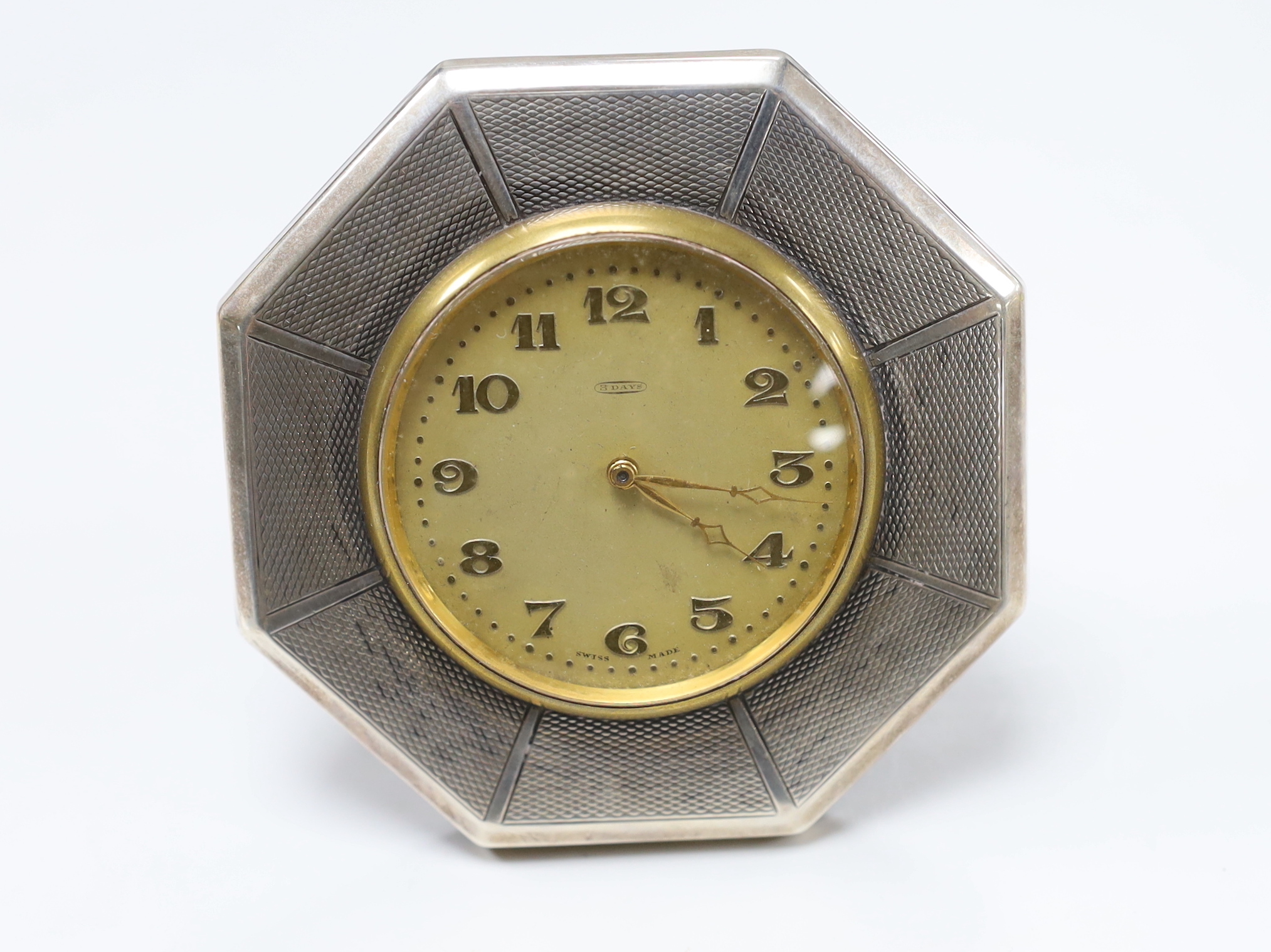 A George V silver mesh evening bag, 10.9oz and a silver mounted 8-day timepiece.